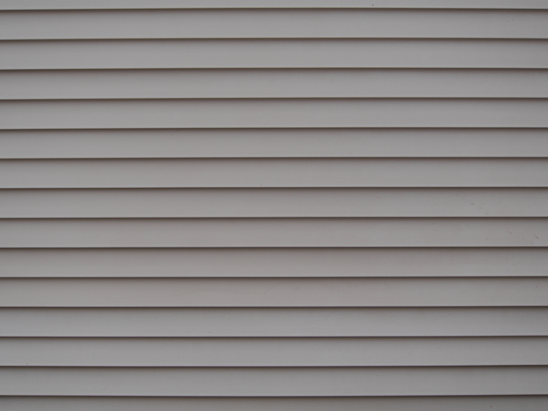 Grey vinyl horizontal lap siding panels - 1st Capital Certified Roofing Austin TX