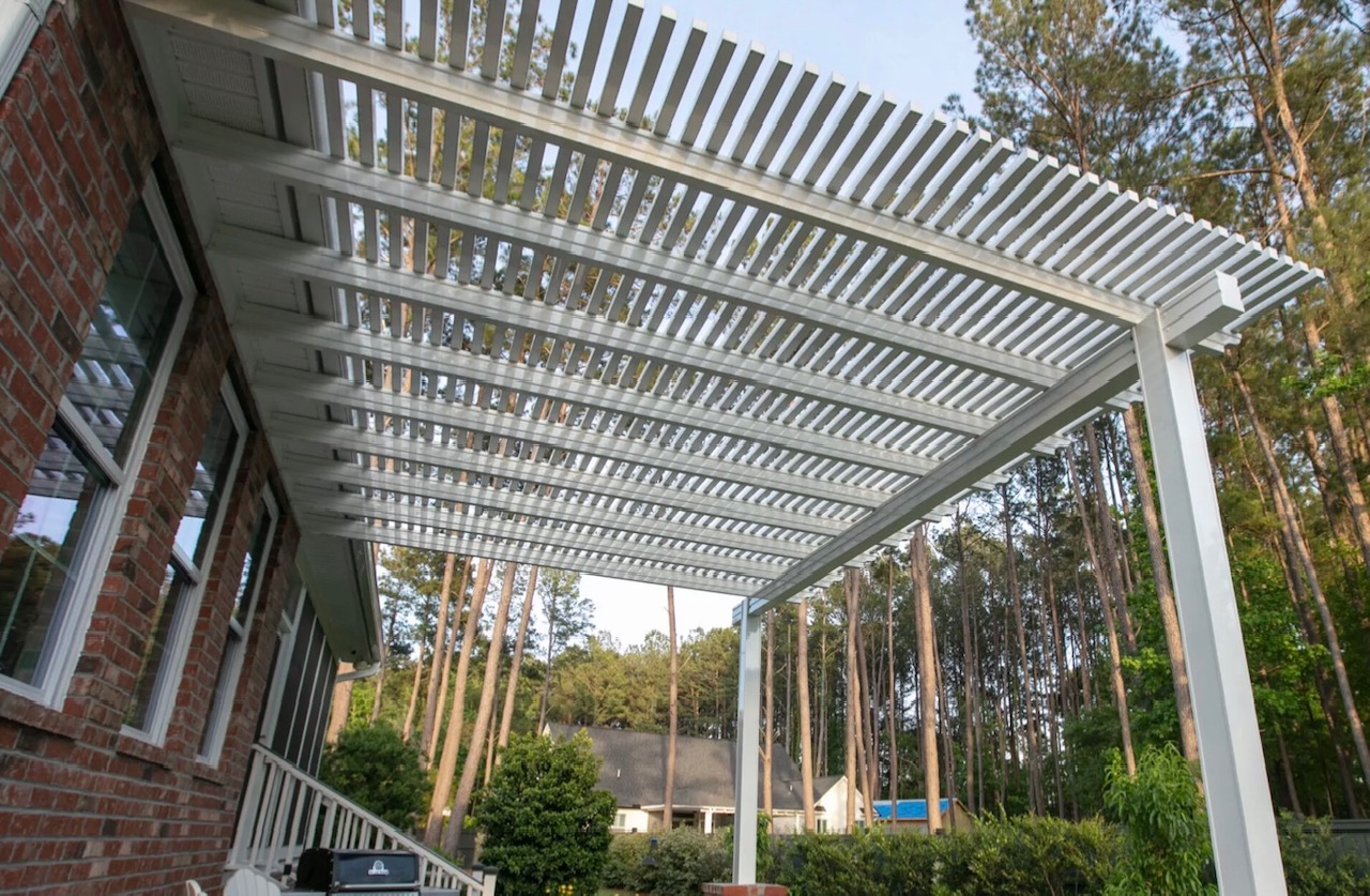 Open louvered pergola attached to brick home - Austin TX